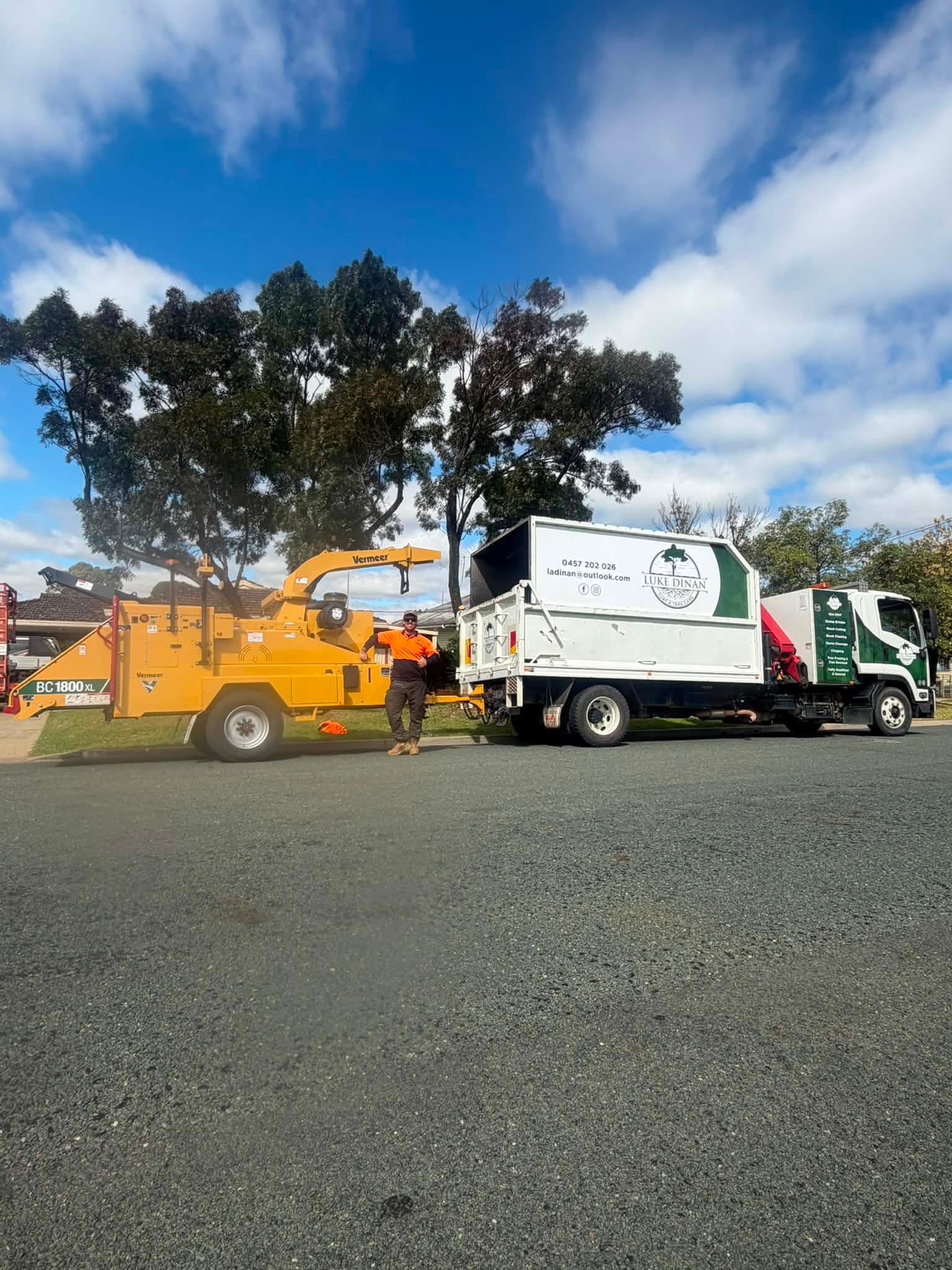 Luke Dinan Turf & Tree Care branded truck and wood chipper on site